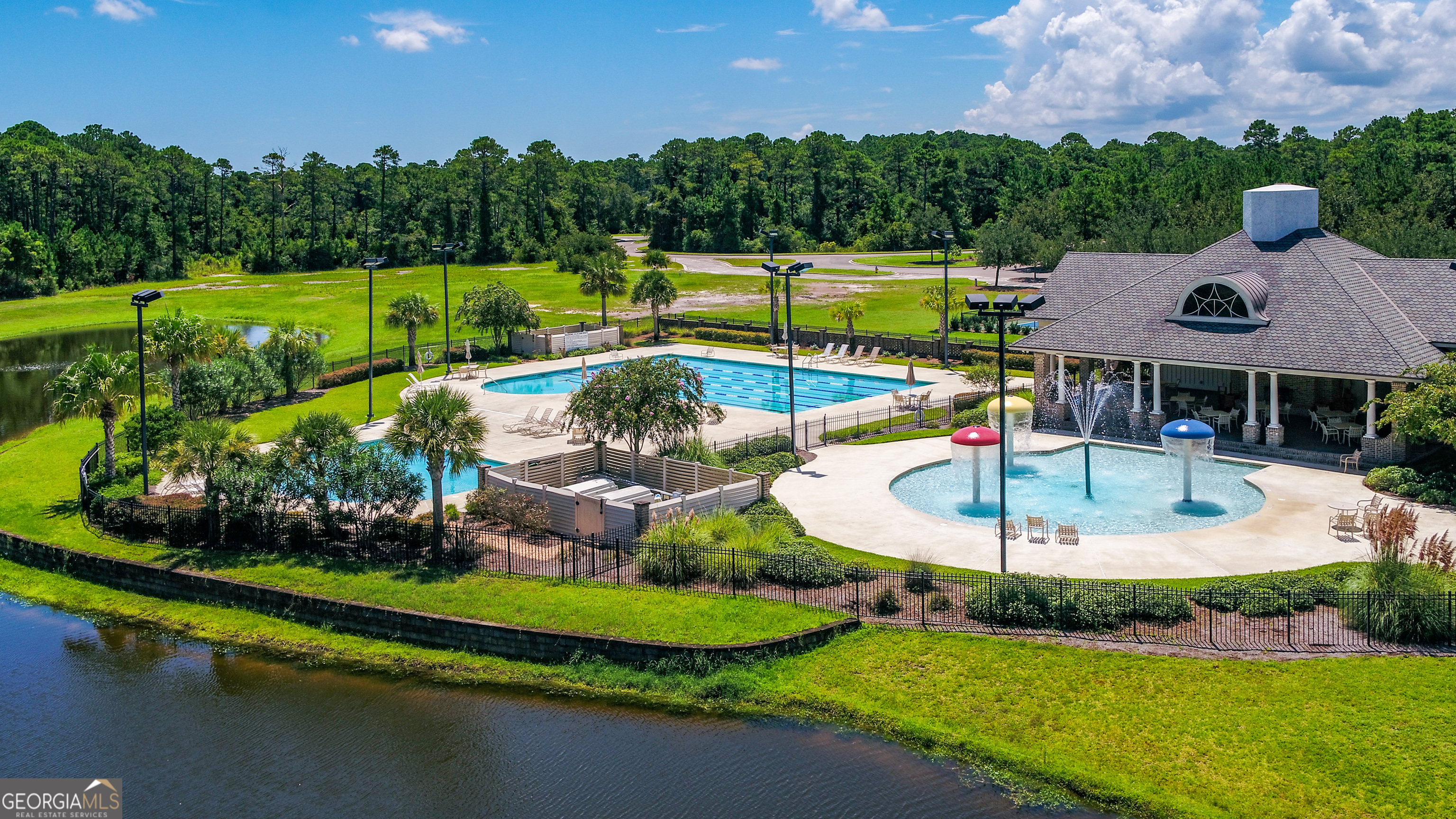 a aerial view of a house with swimming pool and a garden