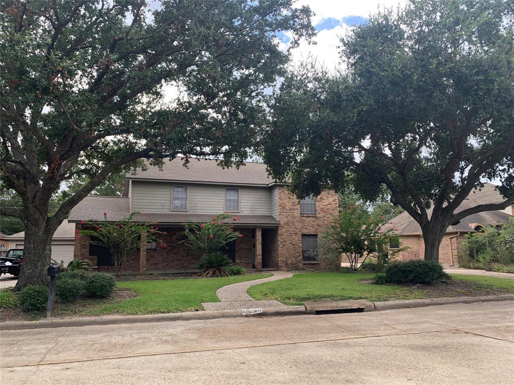 Ranch Style house has gorgeous live oaks and a long porch. Enjoy coffee or just watch the world go by from this comfy front porch.