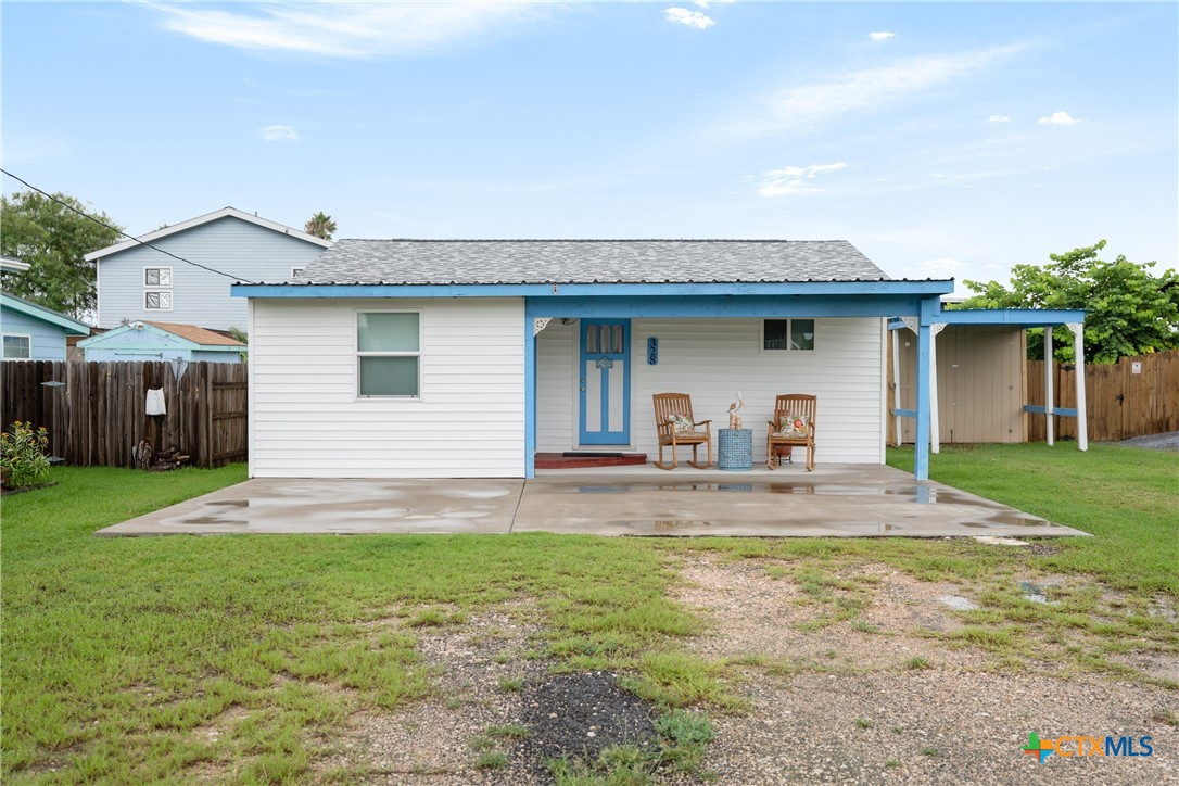 a view of a house with a yard and a patio