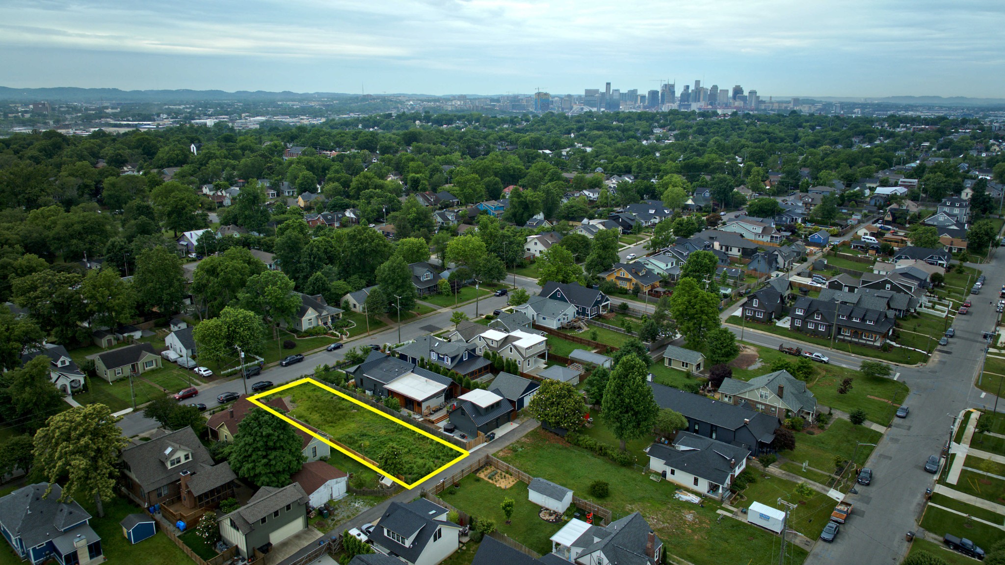 an aerial view of a residential houses with city view