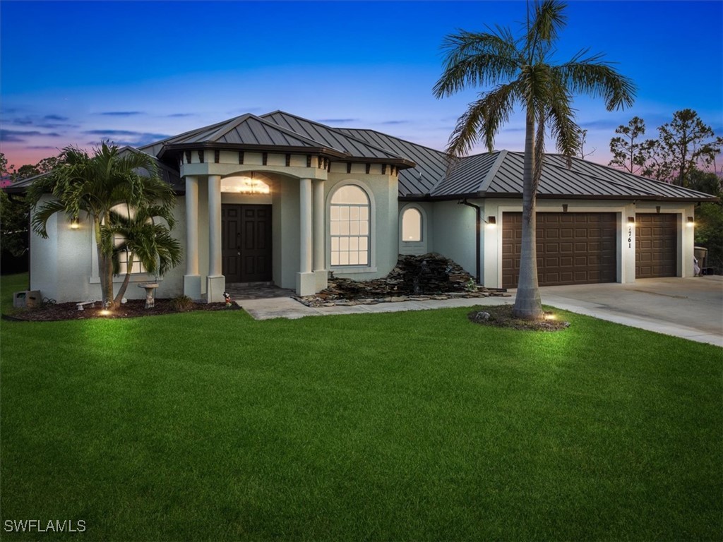 a front view of a house with a garden and plants