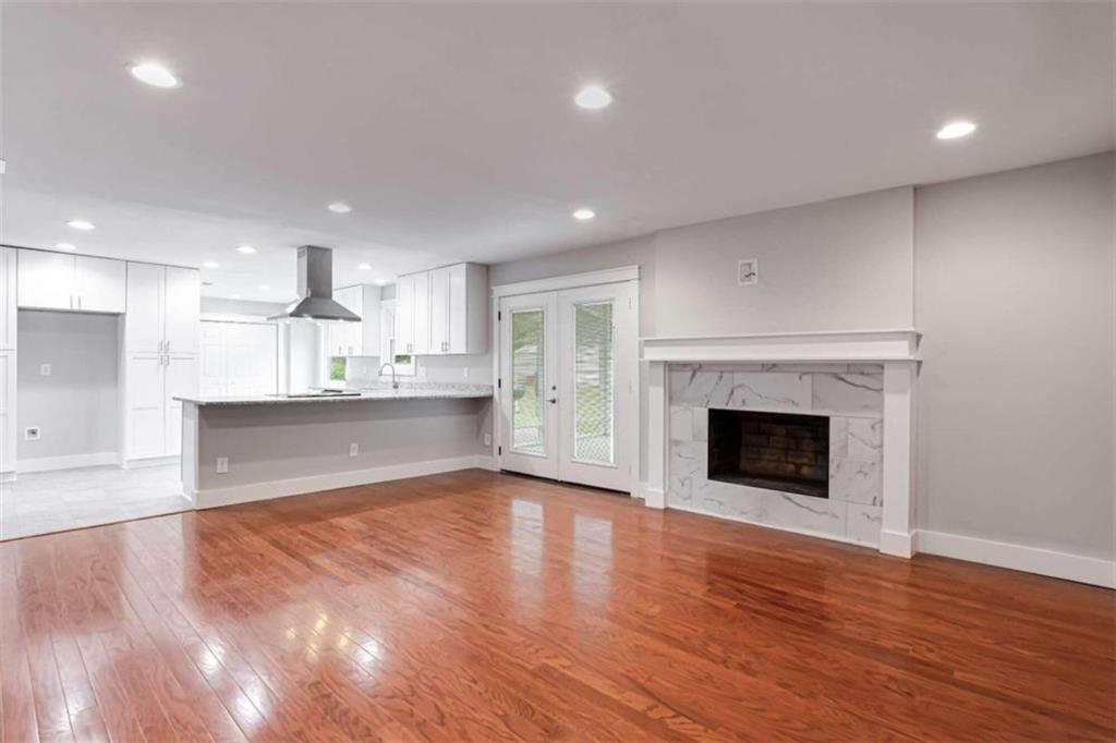 a view of a kitchen with a sink and a fireplace