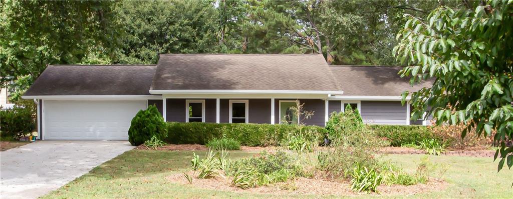 a view of a house with a yard and plants