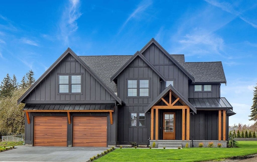 a front view of a house with yard and green space