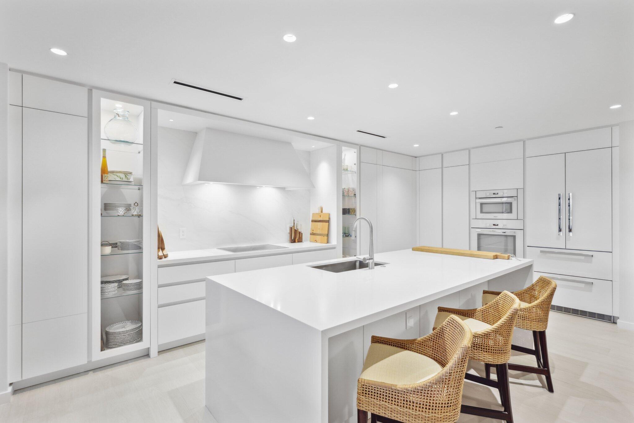 a kitchen with a table chairs refrigerator and cabinets