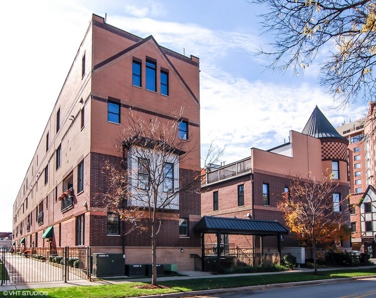 a front view of a residential apartment building with a yard