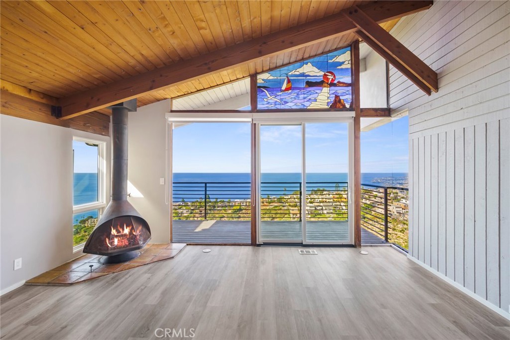 a view of an outdoor space with wooden floor and a ceiling fan