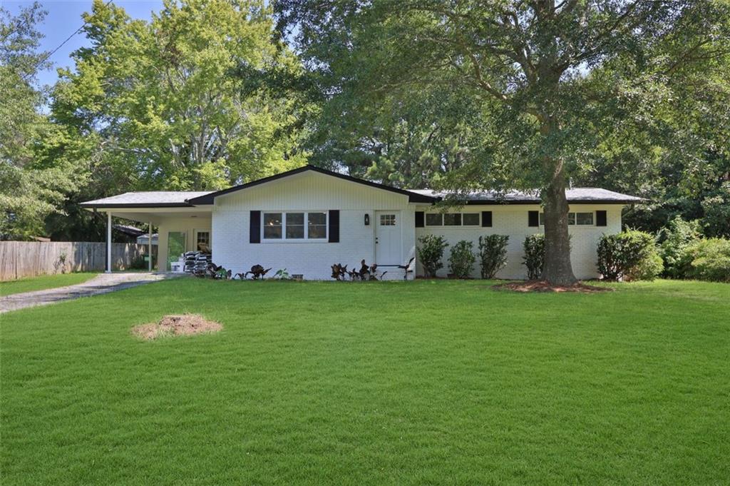 a front view of a house with a garden