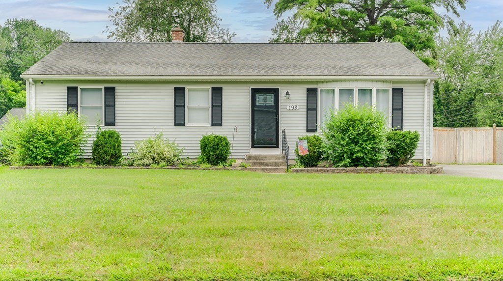 a front view of house with yard and green space