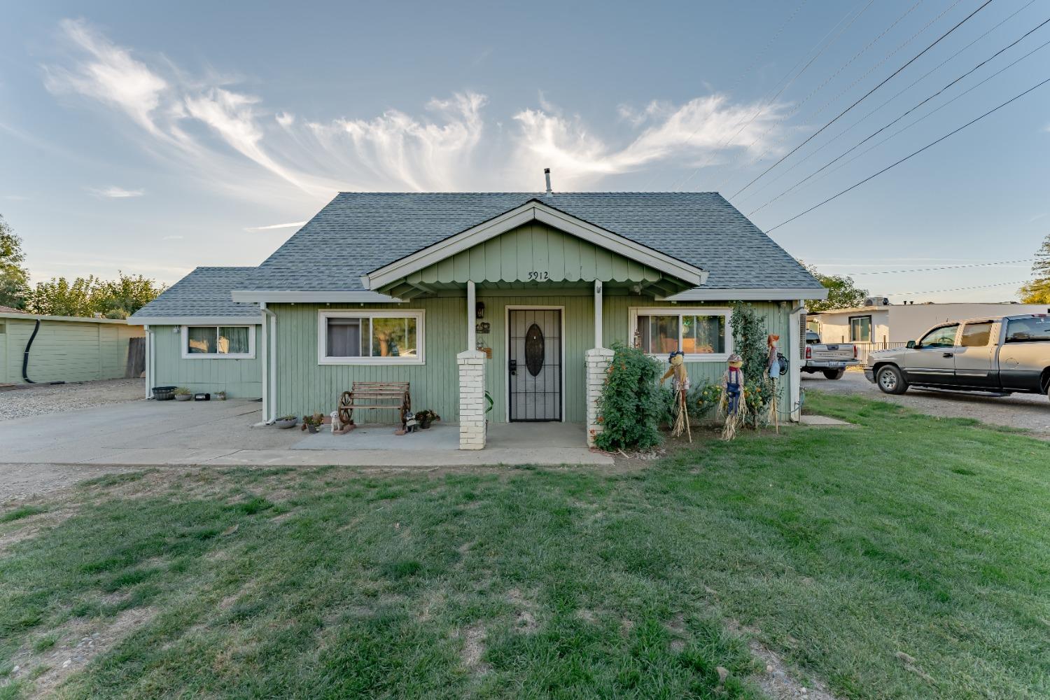 a front view of a house with a garden and yard