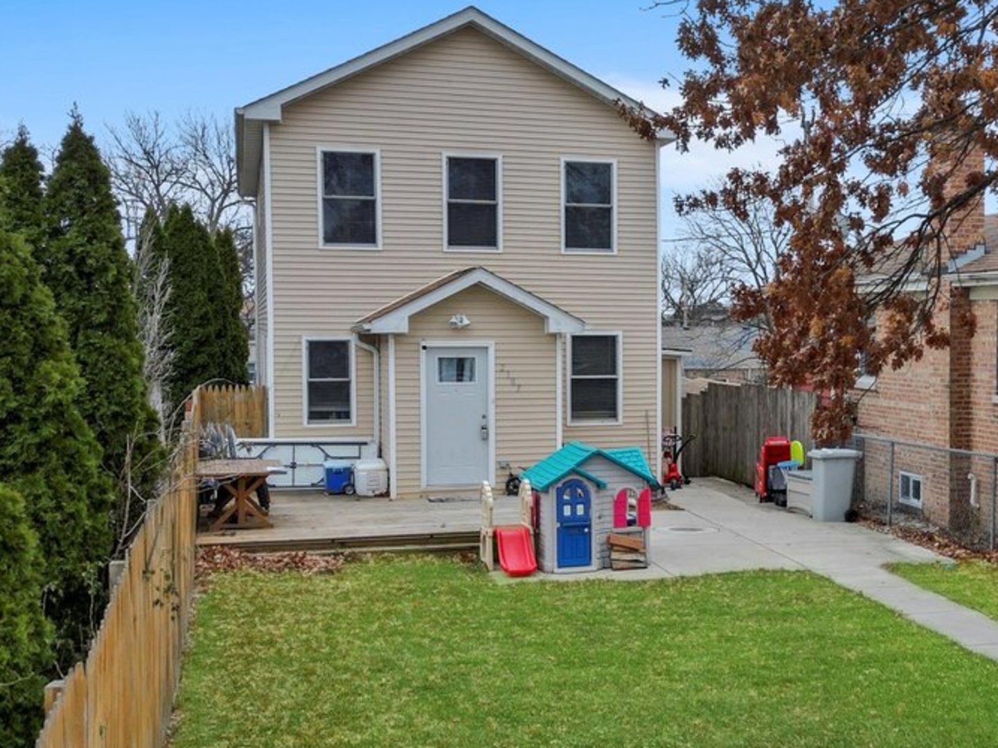 a front view of house with yard and trees