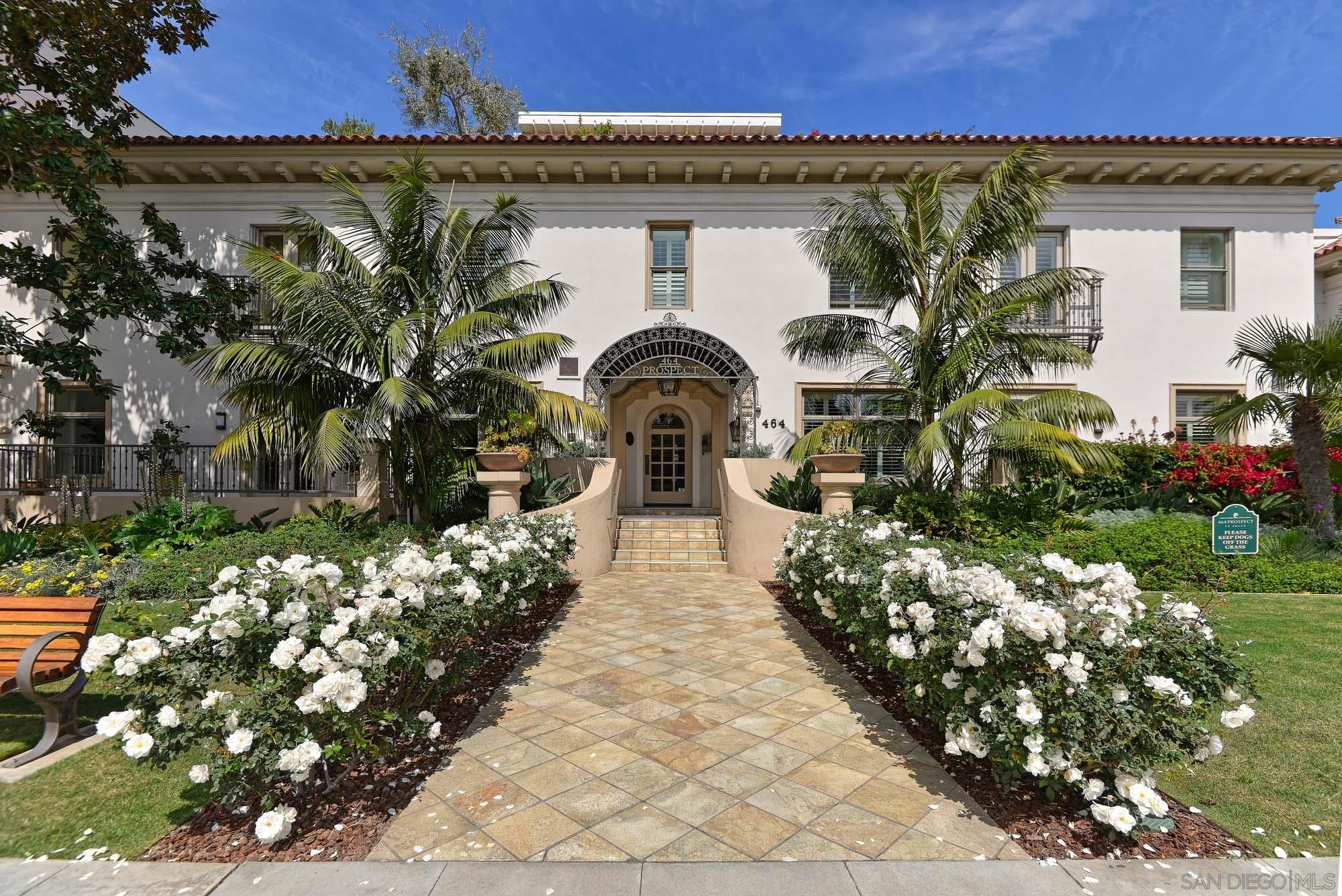 a front view of a house with lots of flowers