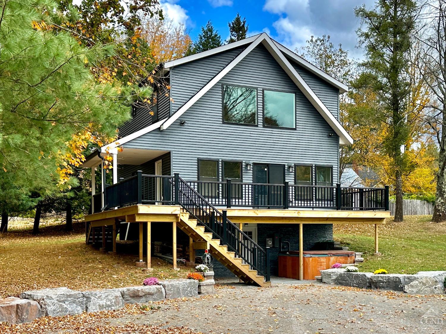 a view of a house with a yard and sitting area