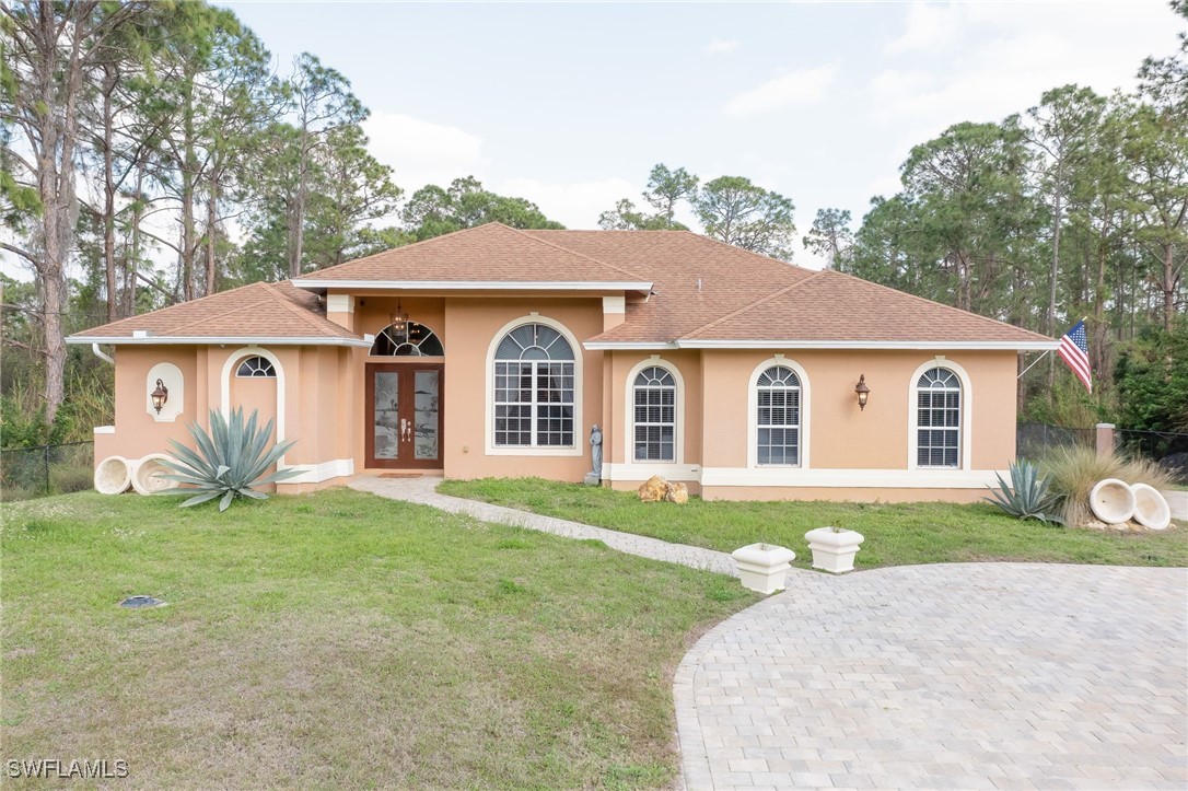 a front view of a house with a garden