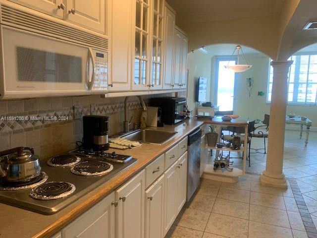 a kitchen with a sink stove and cabinets