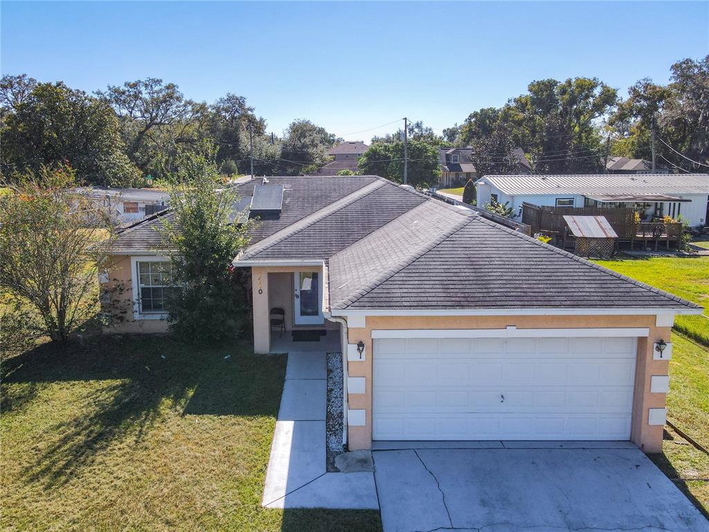 a aerial view of a house with swimming pool and a yard