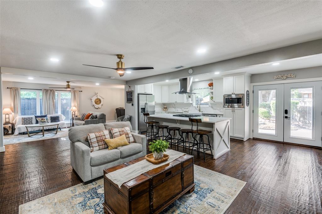 a living room with furniture and kitchen view