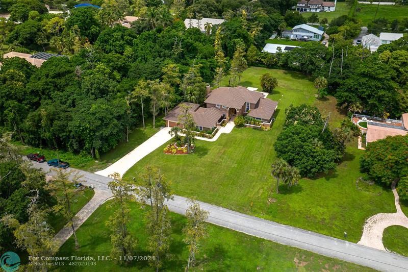 an aerial view of residential houses with outdoor space and street view