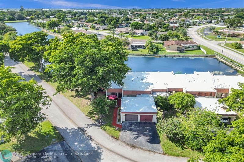 an aerial view of residential houses with outdoor space and street view