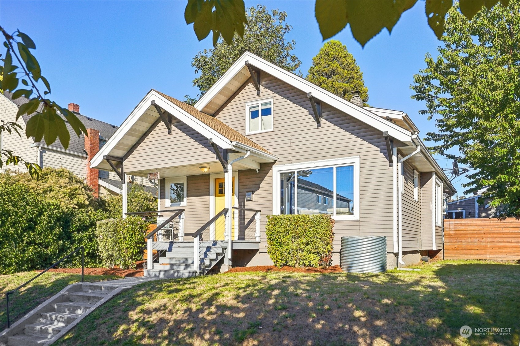 a view of a house with backyard and sitting area