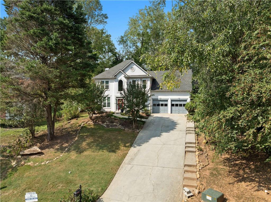 a front view of a house with a garden