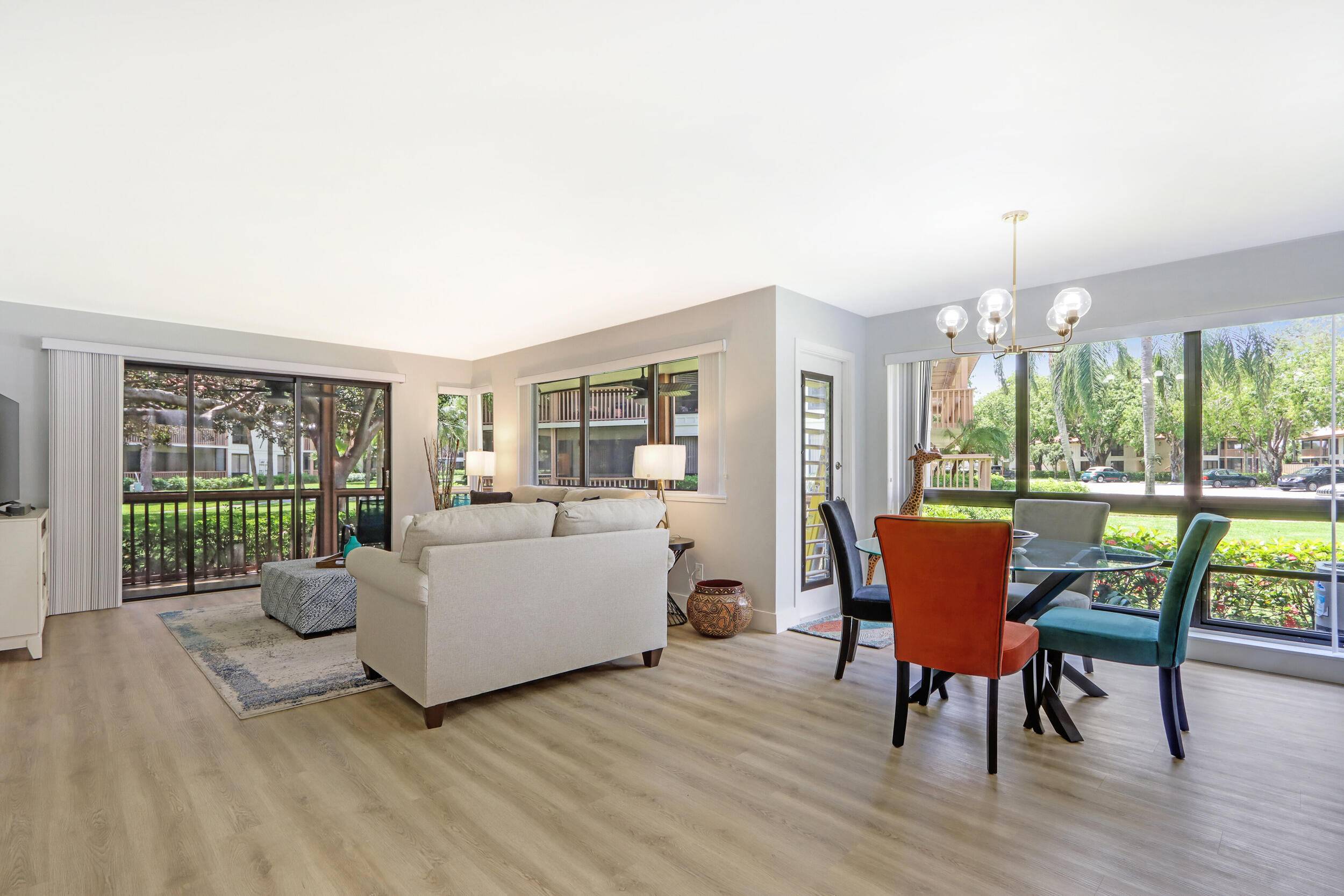 a living room with furniture and a floor to ceiling window