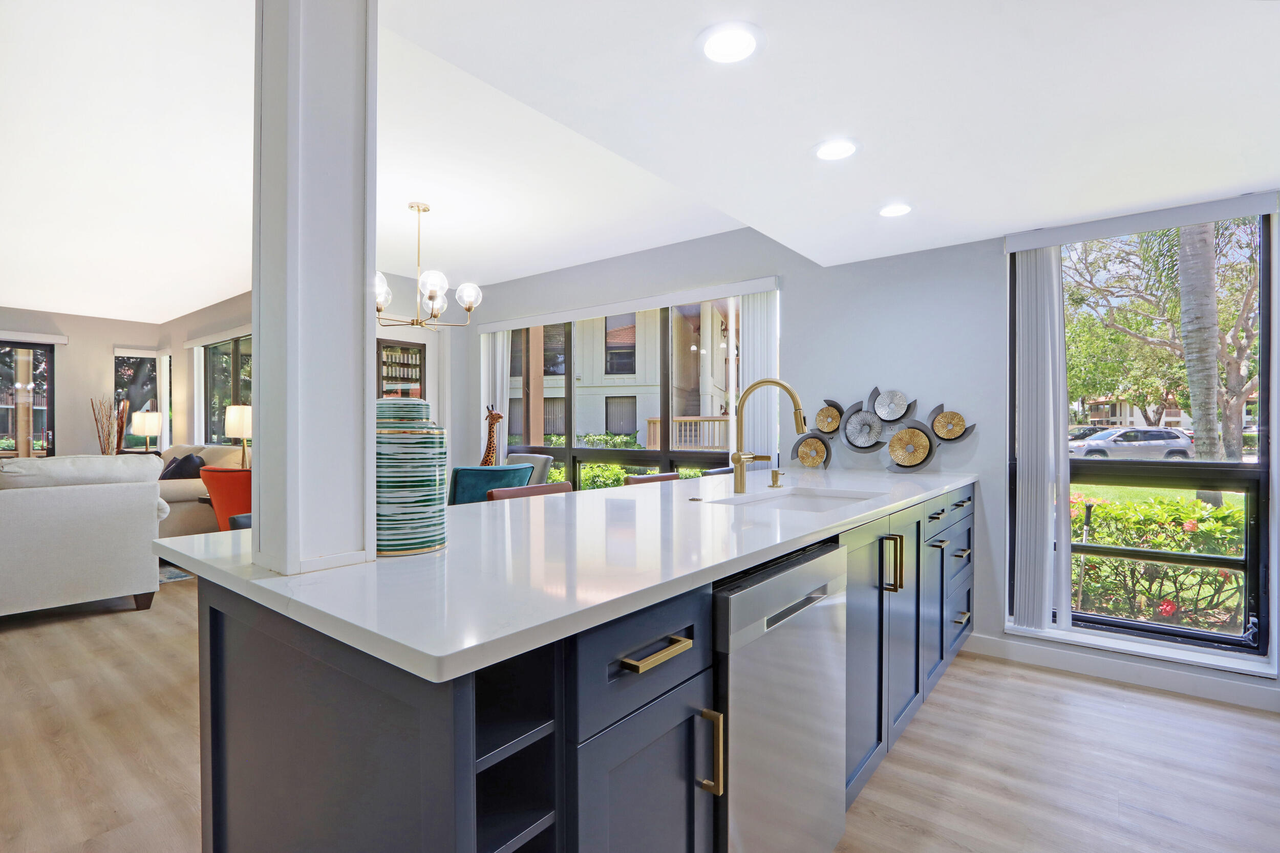 a kitchen with counter top space and wooden floor