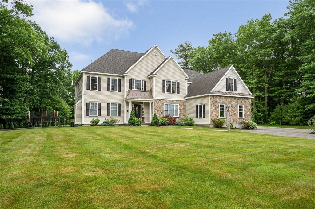 a front view of a house with a garden