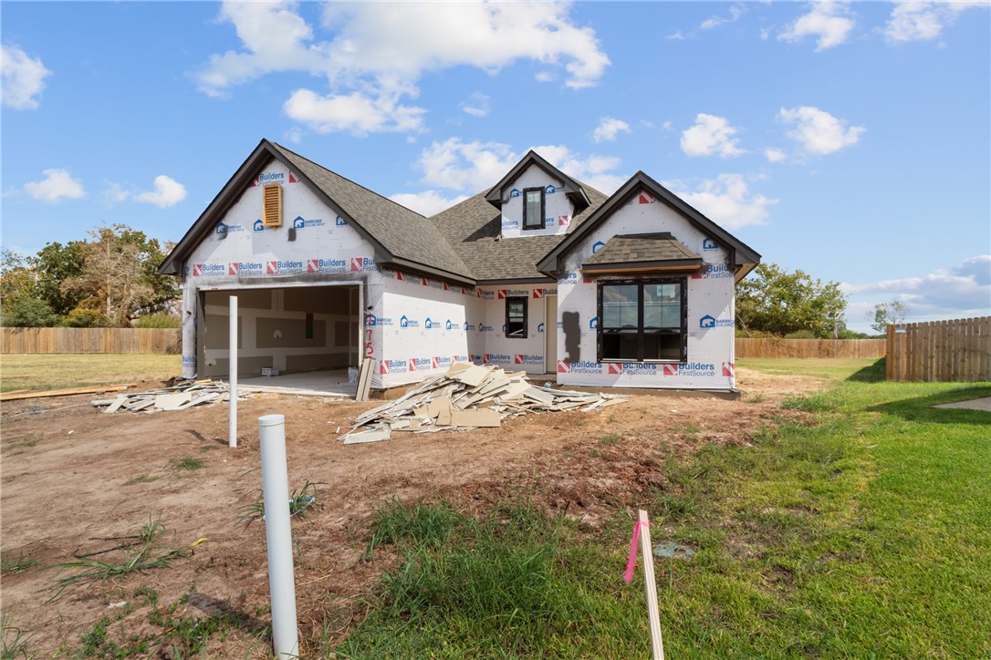 a front view of a house with yard and garage