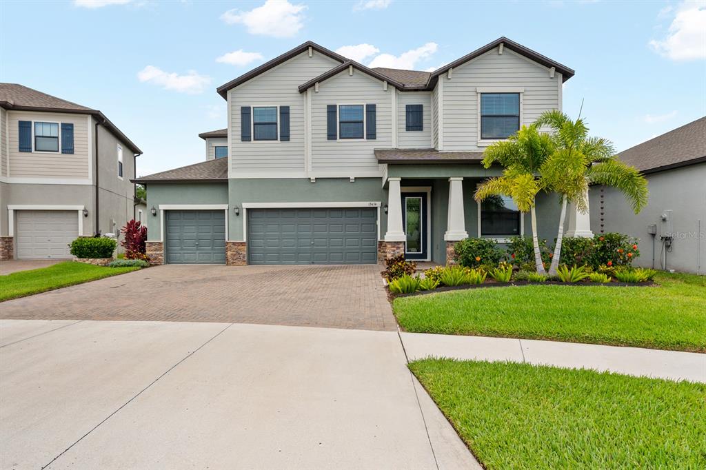 a front view of a house with a yard and garage