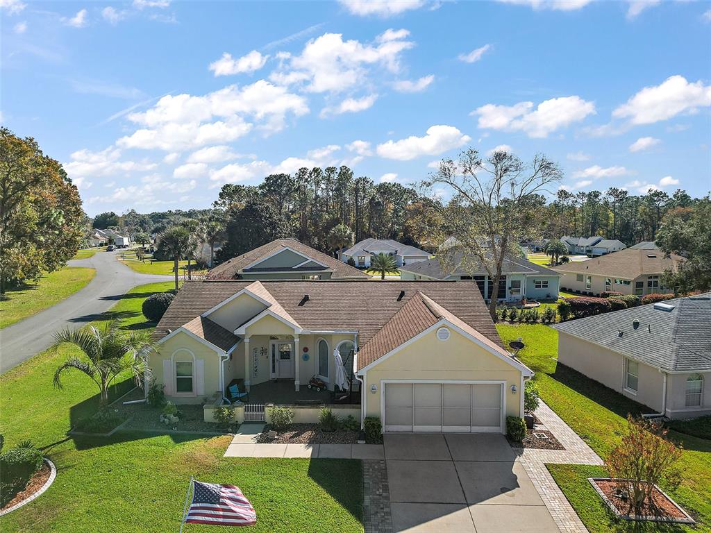 a aerial view of a house with swimming pool and a yard