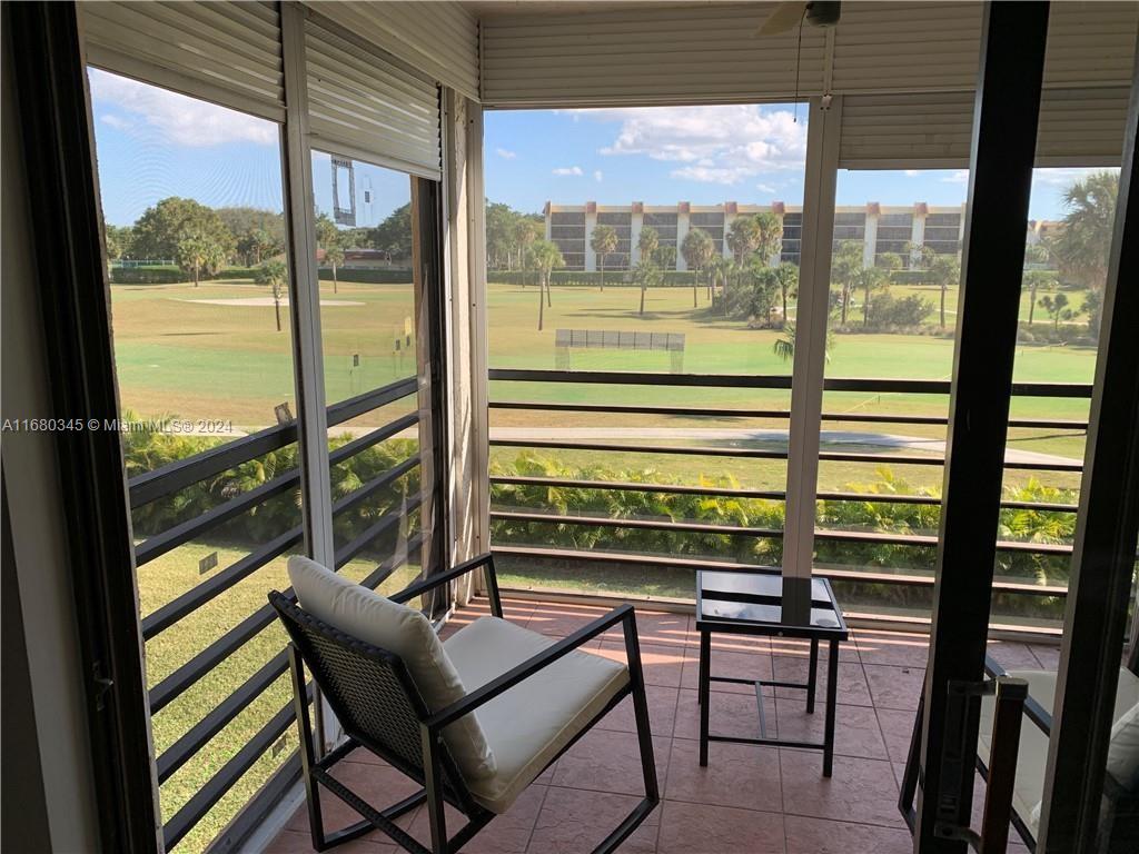 a view of a two chairs in the balcony