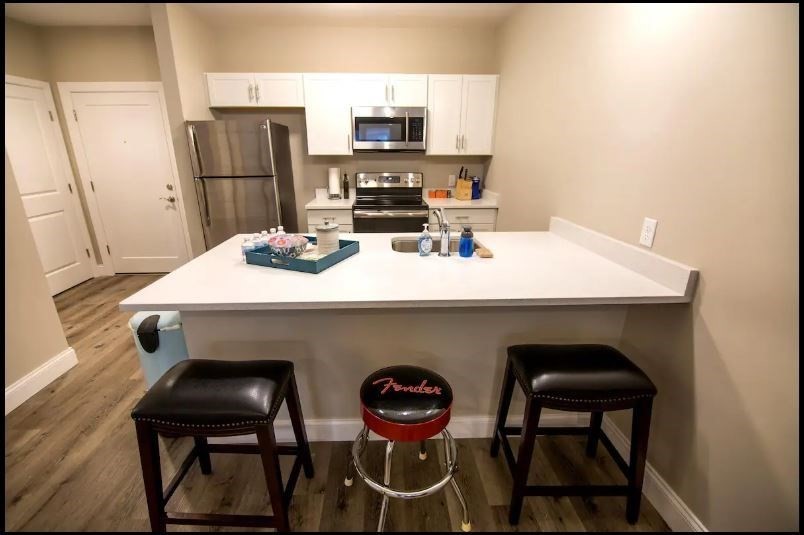 a kitchen with a table chairs and refrigerator