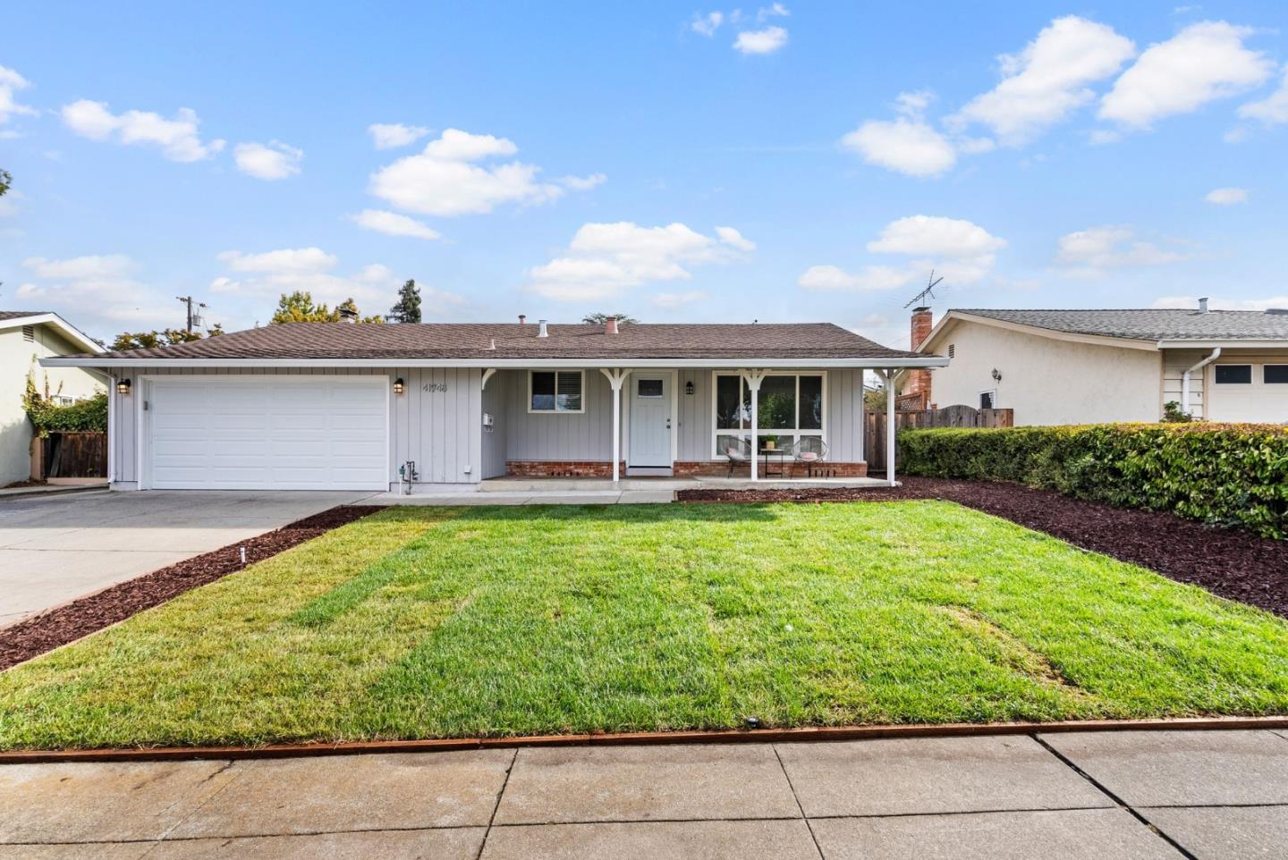 a view of a house with a backyard