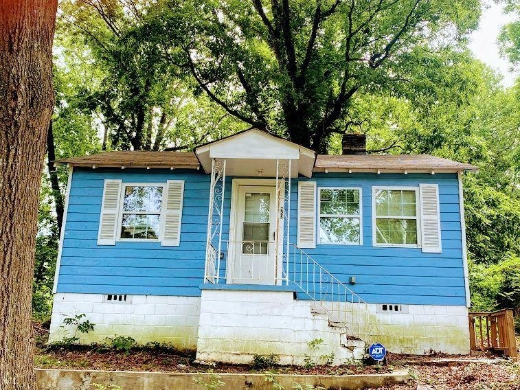 front view of a house with a tree