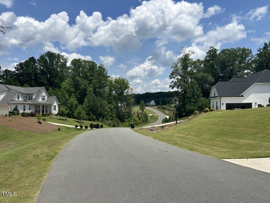 a view of a house with pool and a yard