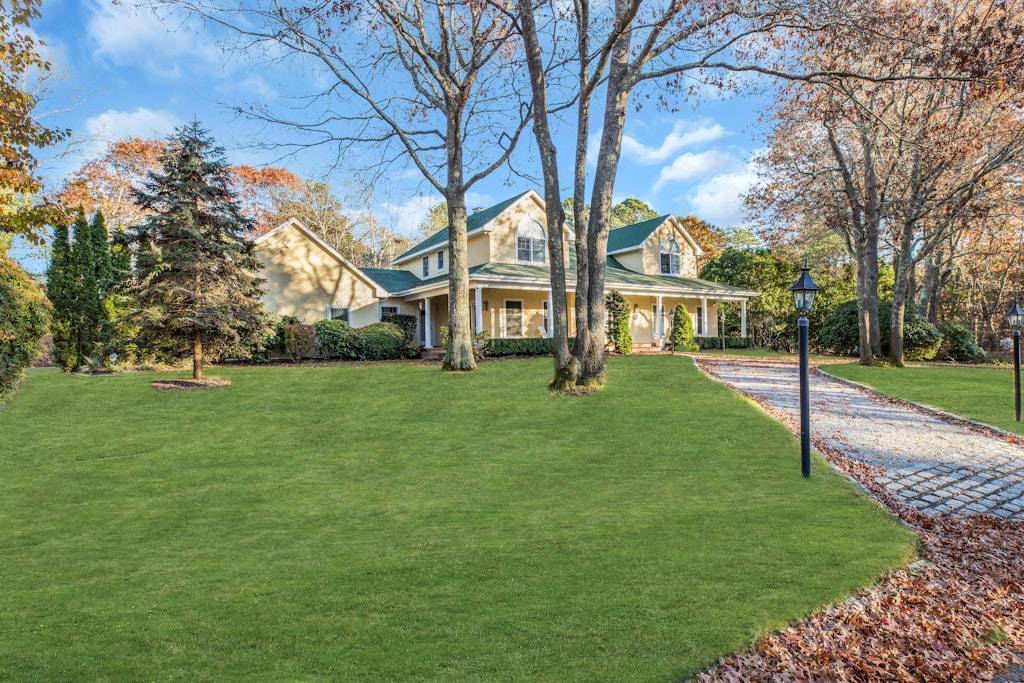 a view of house with a backyard