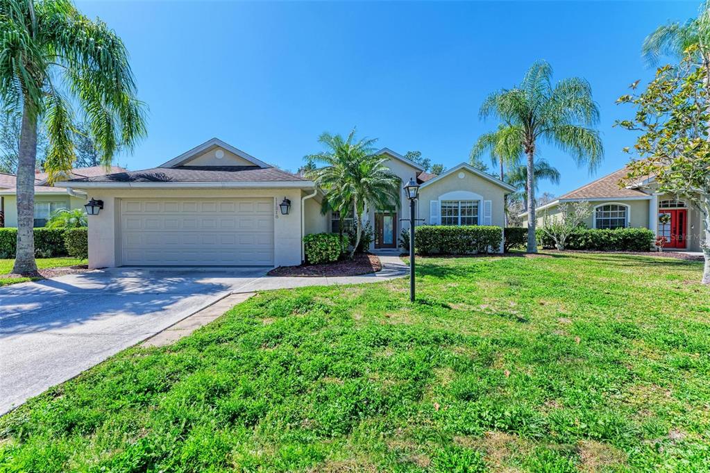 a front view of a house with a yard and garage