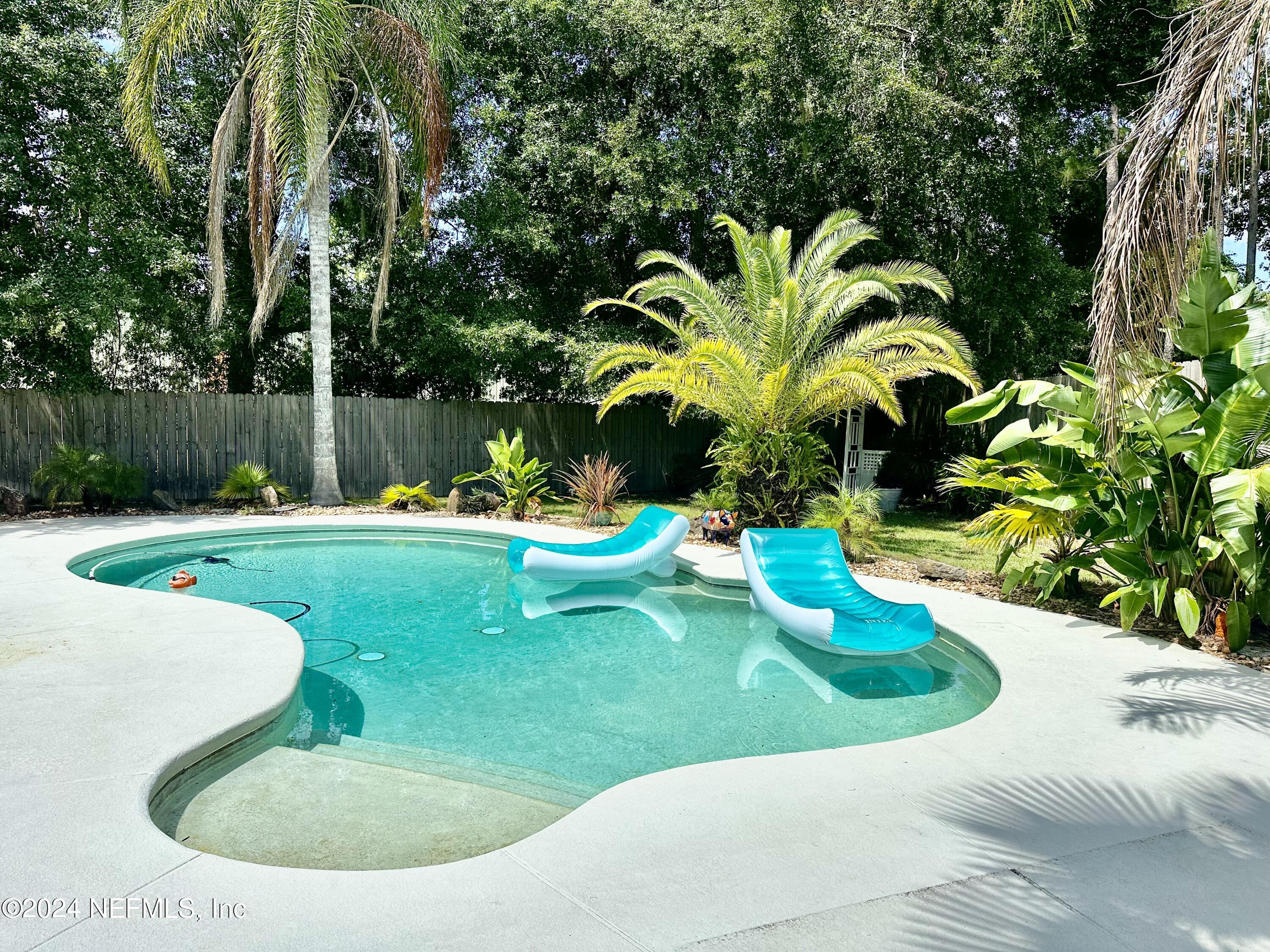 a view of a swimming pool with a yard