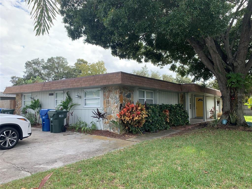 a view of a house with a yard and a garage