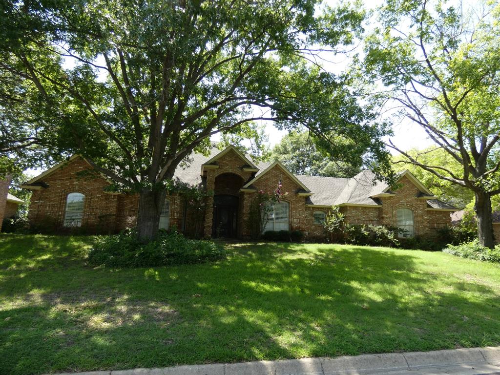 a front view of house with yard and green space