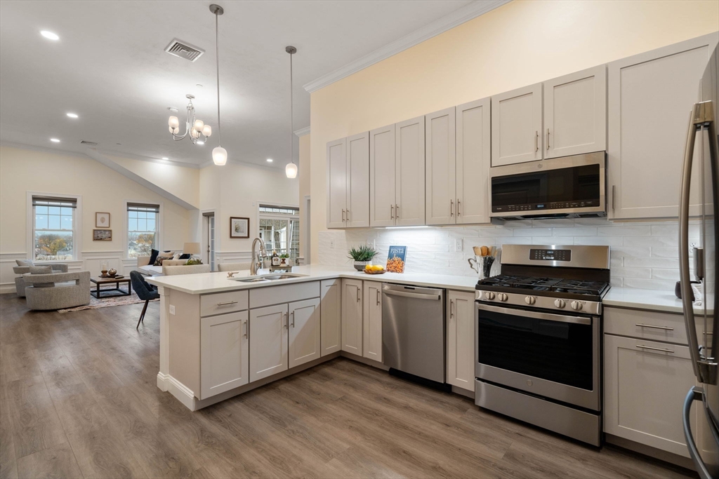 a kitchen with a sink stove and microwave