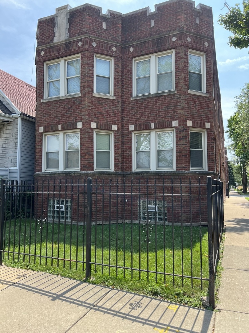 a view of a brick building with a yard