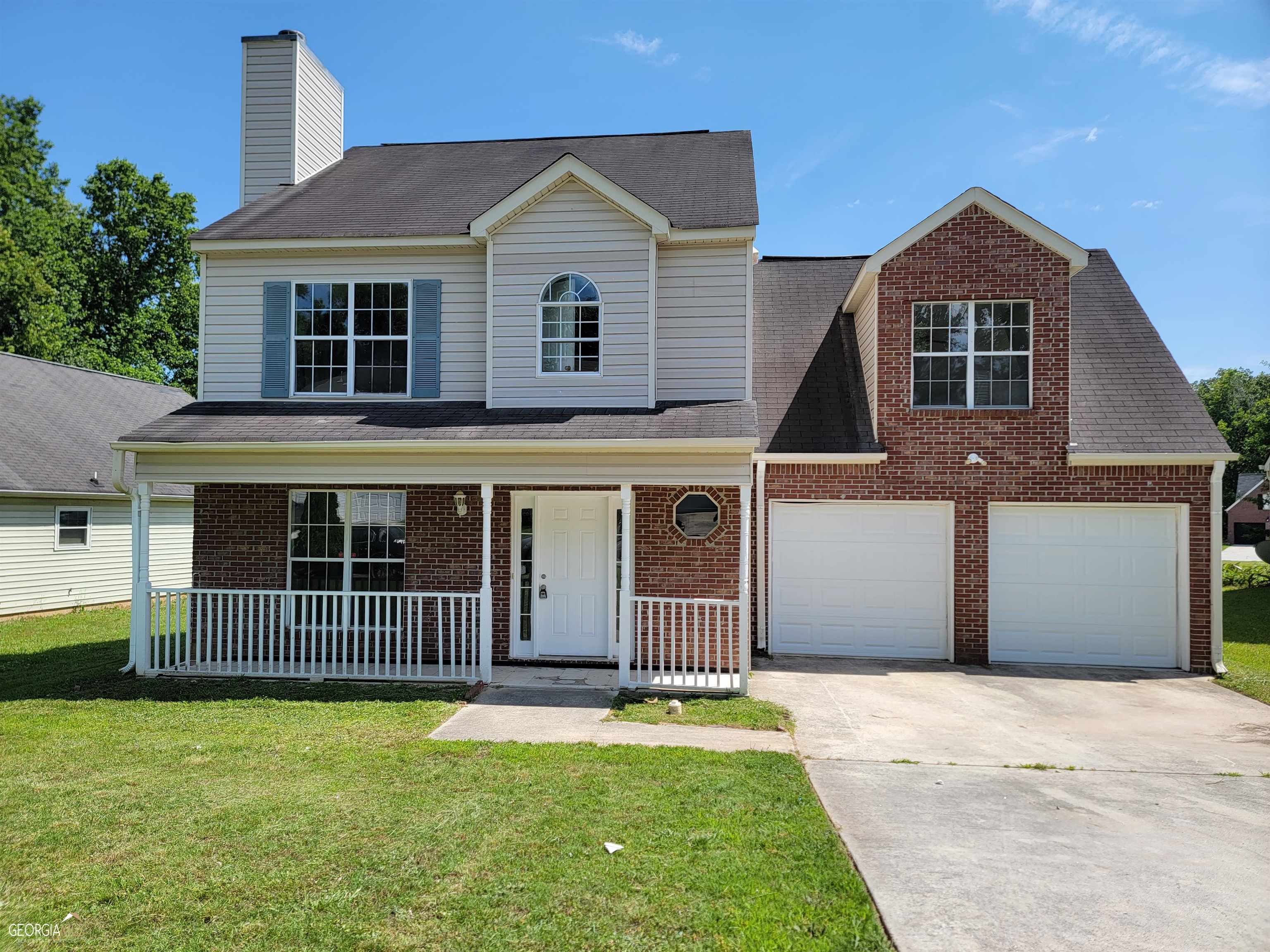 a front view of a house with a garden