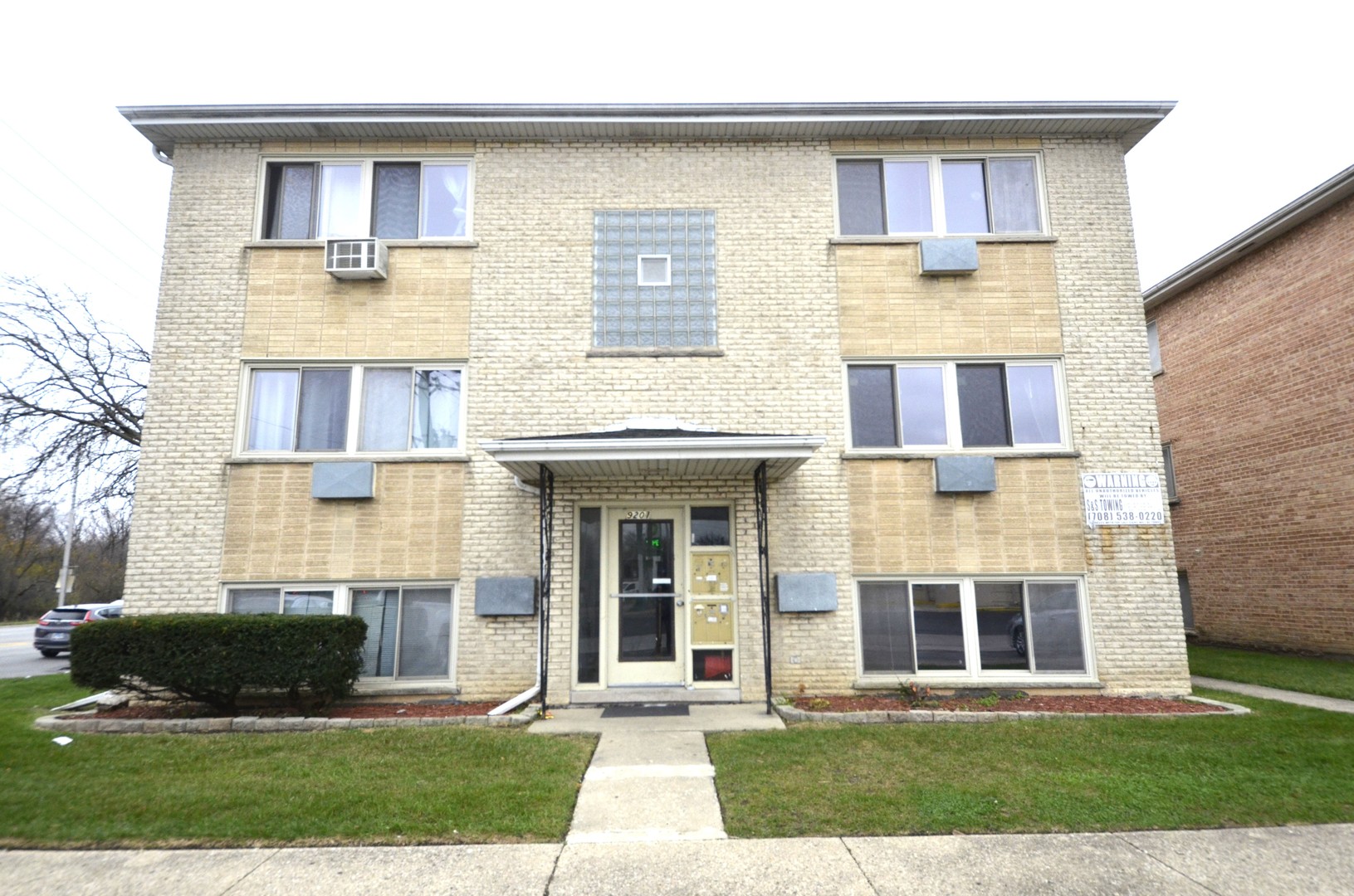 a front view of a house with a yard and plants