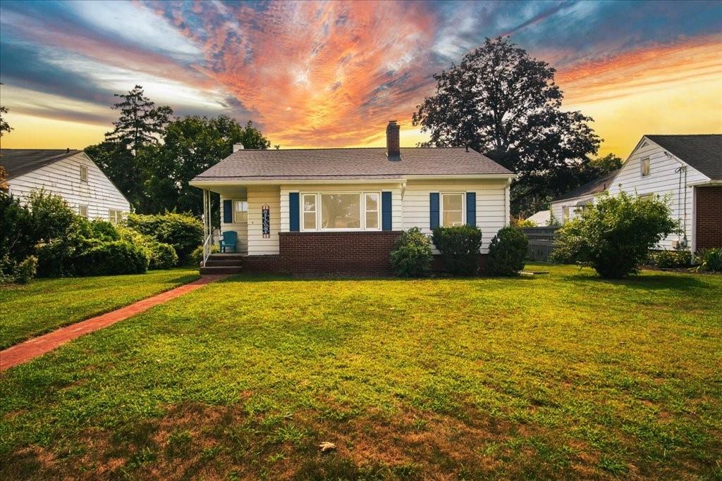 a front view of house with yard and green space