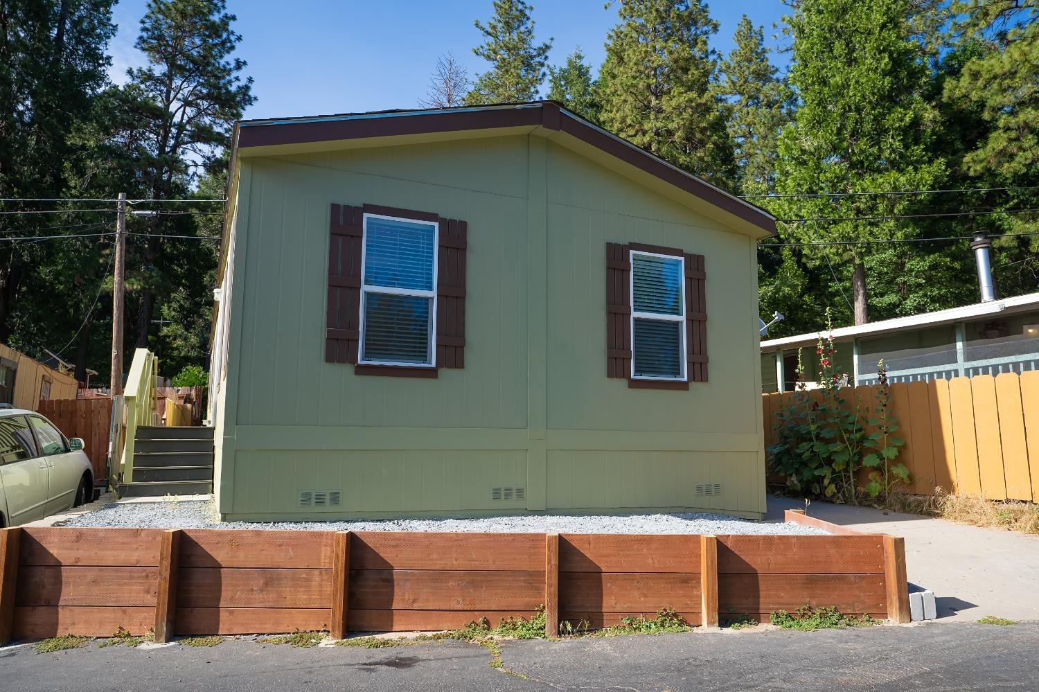 a backyard of a house with yard and outdoor seating