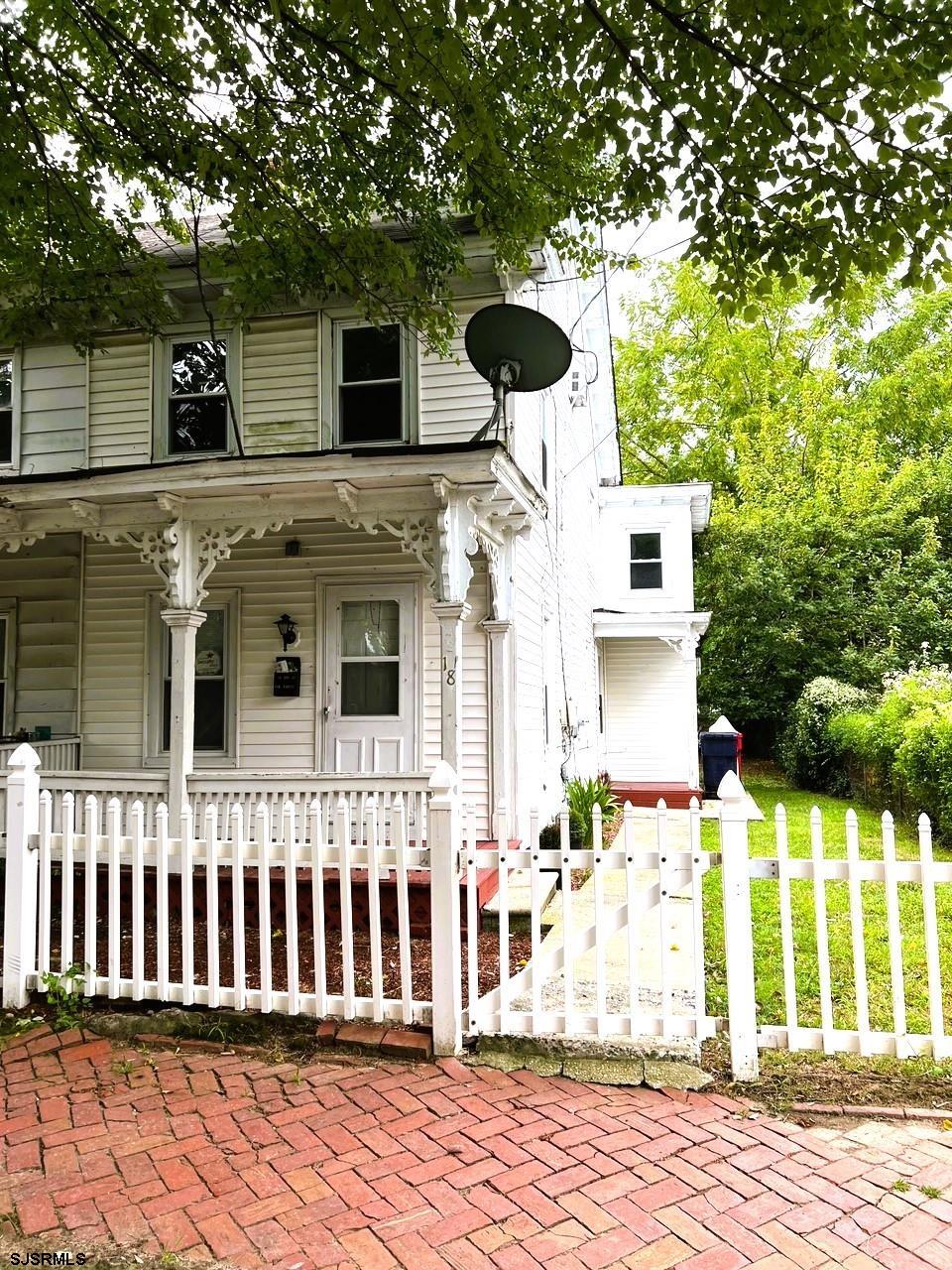 a front view of a house with a fence