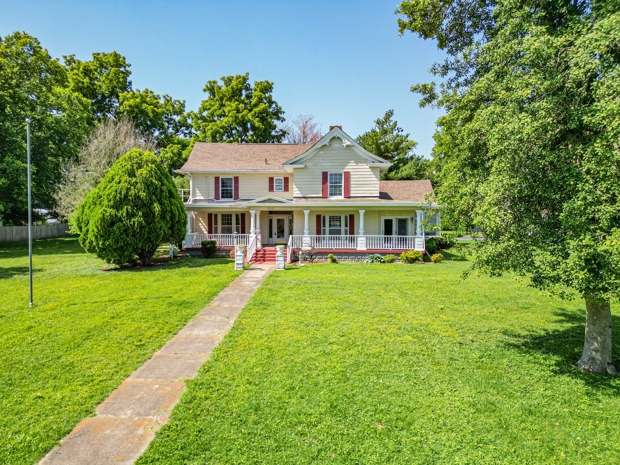 a front view of house with yard and green space