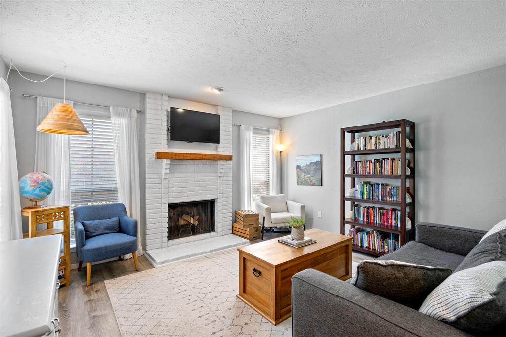 a living room with furniture fireplace and rug